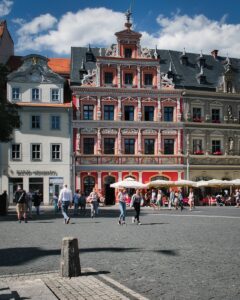 people walking on street near red building during daytime