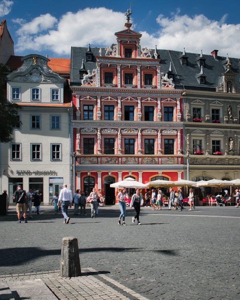 people walking on street near red building during daytime